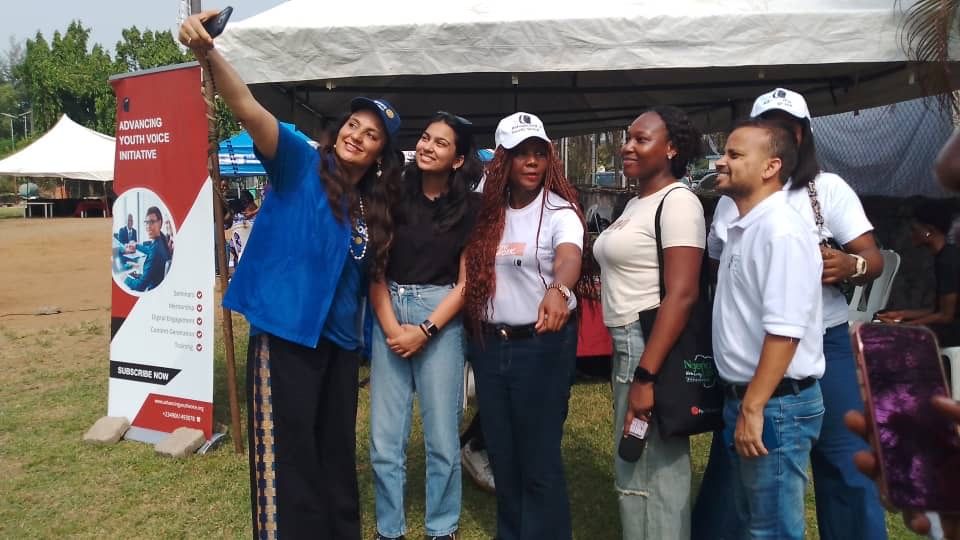 Soumya Goel taking a selfie with partners at a community health camp in Lagos